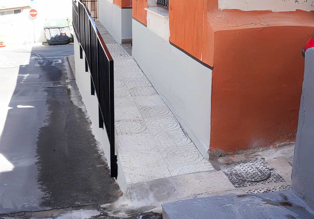 Rampa y acceso adaptado a la vivienda de Antonio en Torreagüera tras la instalación de una nueva barandilla y la eliminación del escalón de entrada